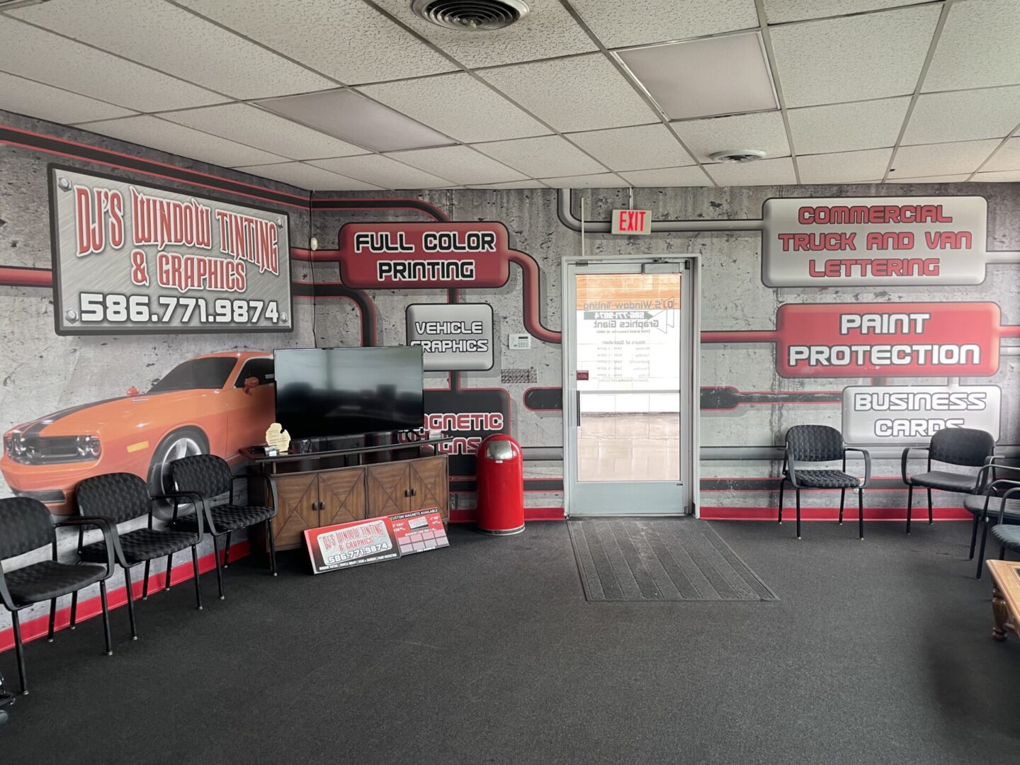 A room with several signs and cars on the wall.