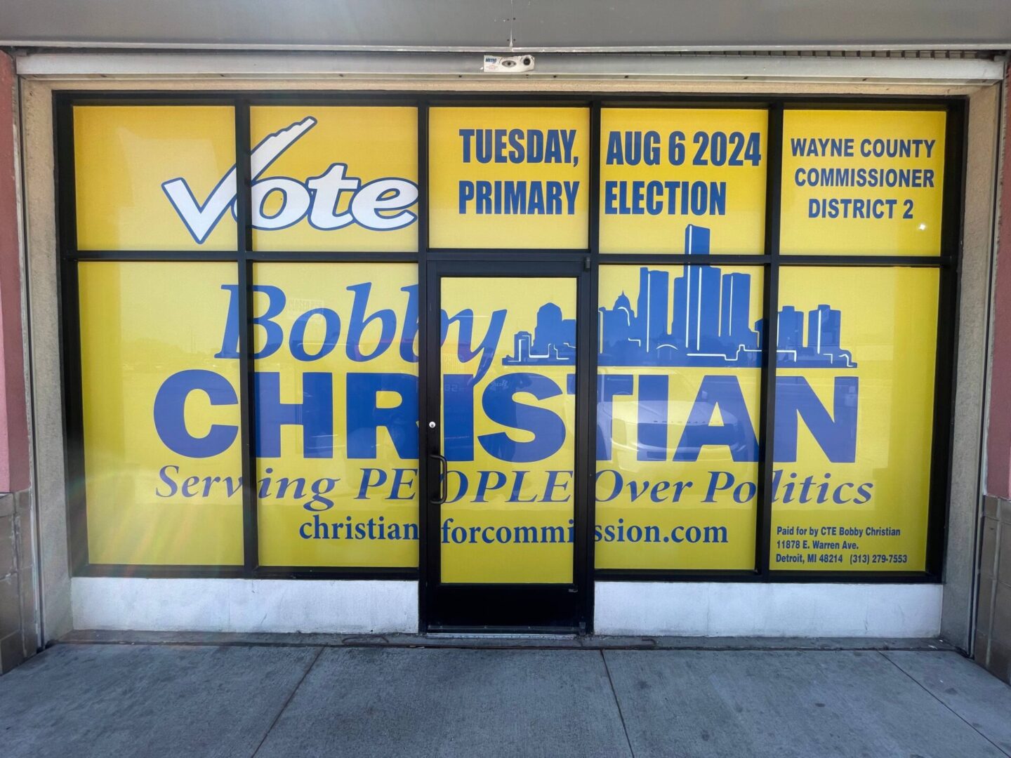 A window with the words " vote bobby christian " on it.