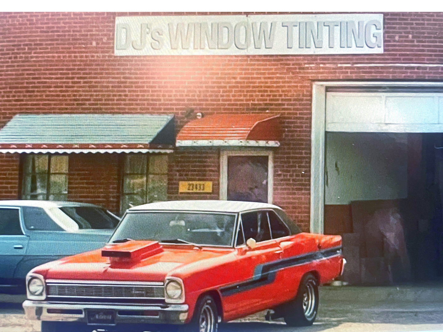 A red car parked in front of a building.