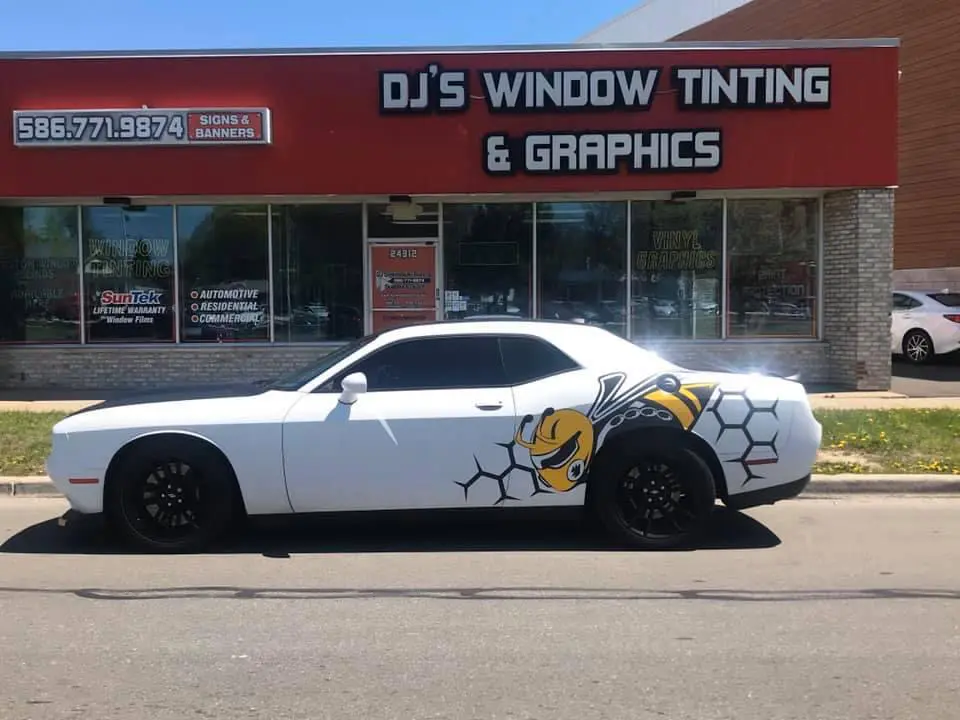 A white car parked in front of a building.