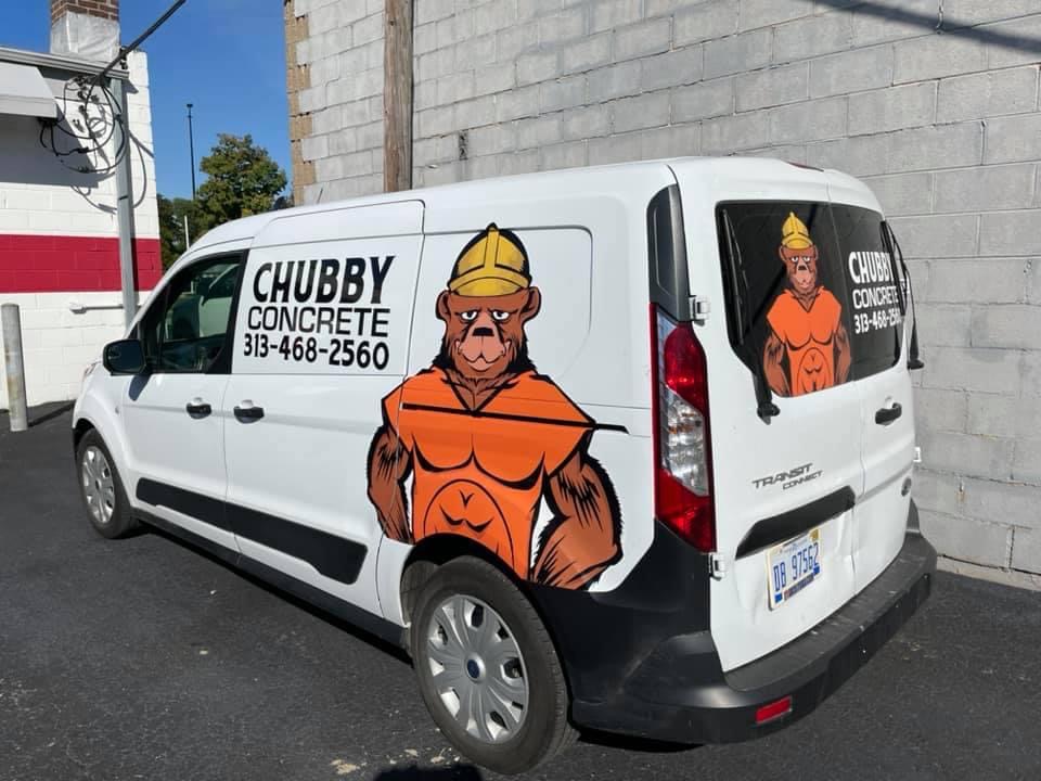 A white van with a monkey on the side of it.