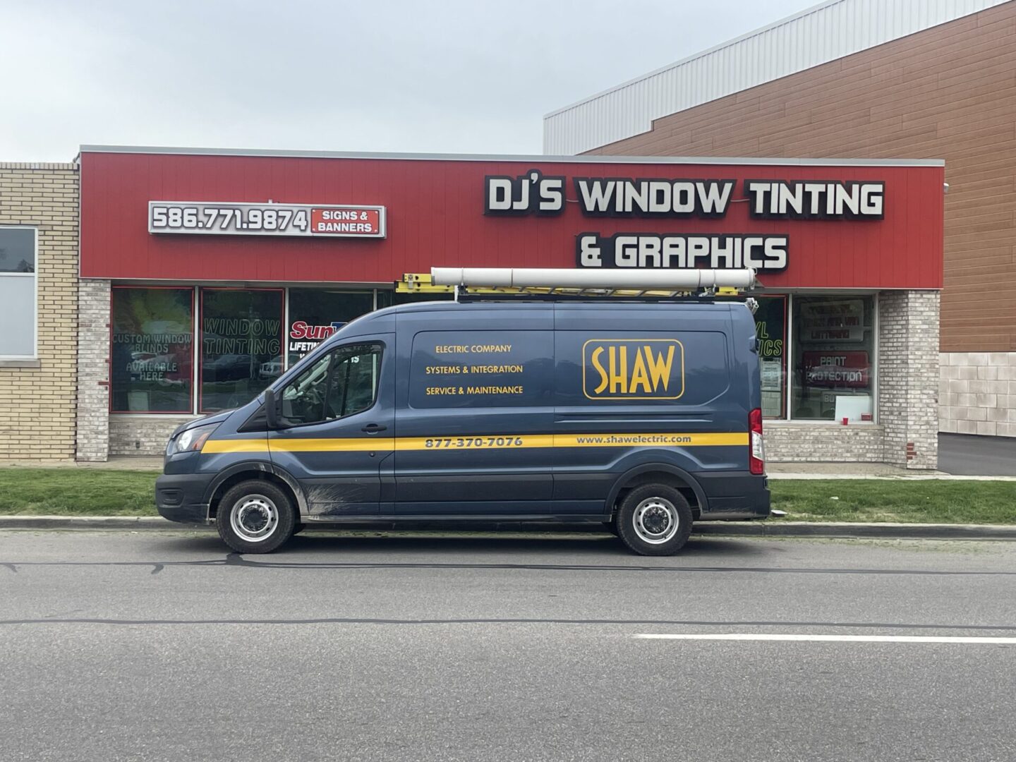 A van parked in front of a building with signs on it.