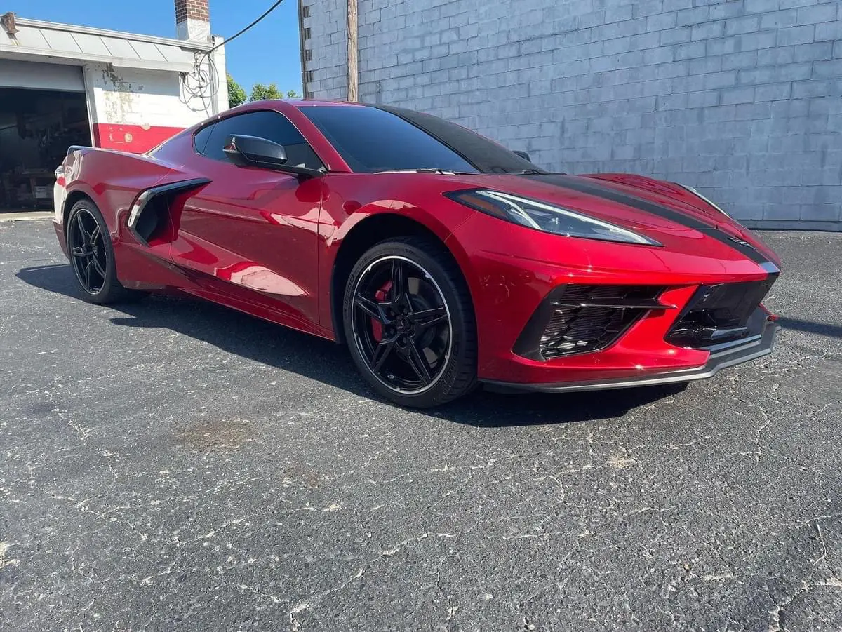 A red sports car parked in front of a building.