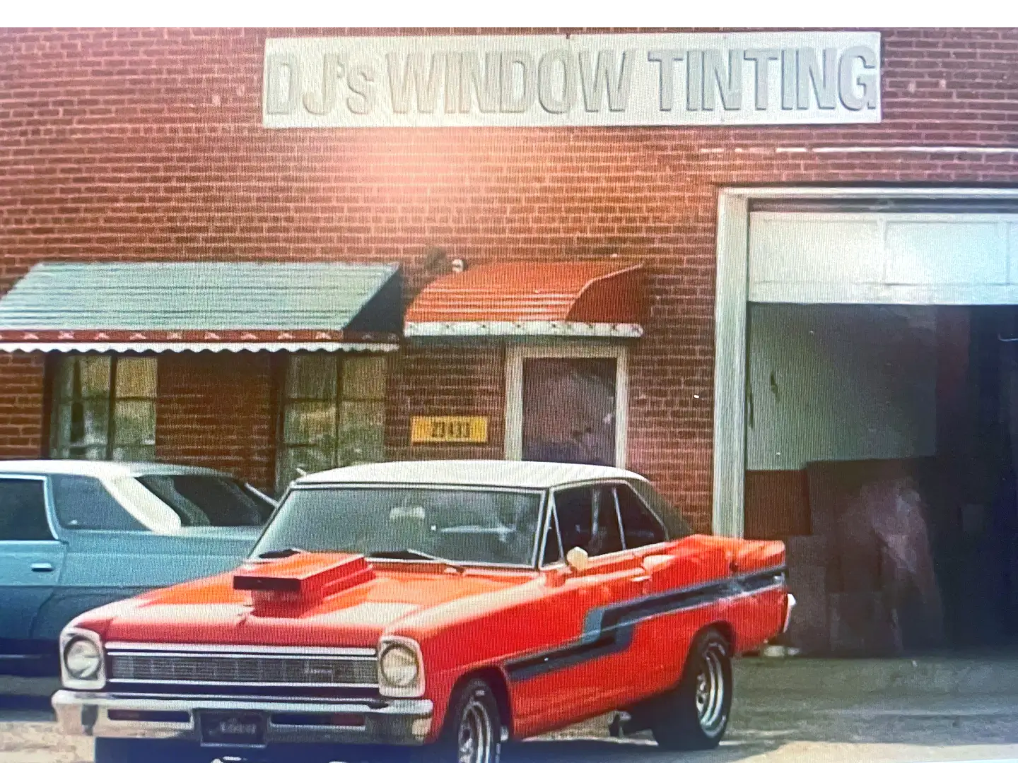 A red car parked in front of a building.